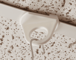 E-Z Round Twist-On Ceiling Loop connected to cables for hanging signs on a drop ceiling